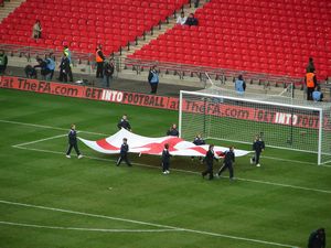 Kids carrying the England flag around the stadium